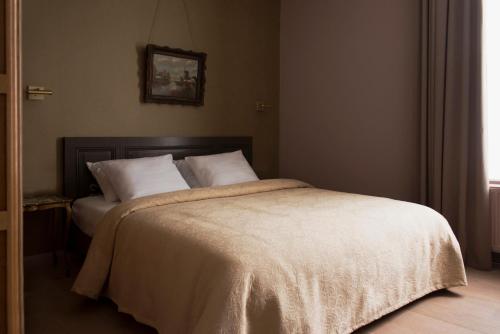 a bedroom with a large bed with white pillows at Boutique hotel Sint Jacob in Maastricht