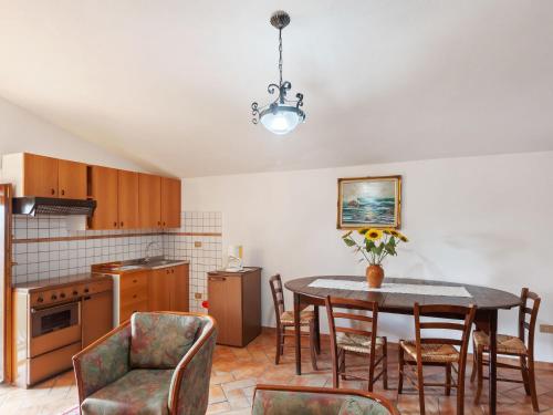 a kitchen with a dining room table and chairs at Charmante Home with Garden in San Valentino