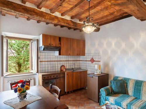 a kitchen with wooden cabinets and a table in a kitchen at Charmante Home with Garden in San Valentino