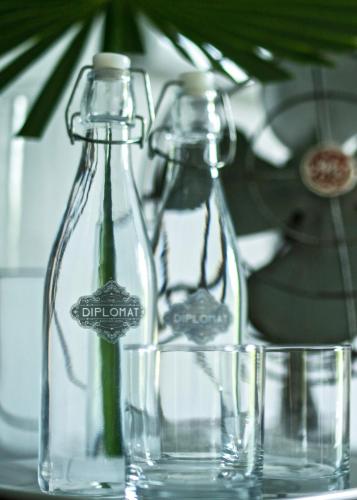 two glass bottles sitting on top of a table at The Diplomat Boutique Hotel in Mérida