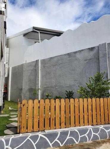 a wooden fence in front of a building at Wind Sea Hill Inn in Hengchun