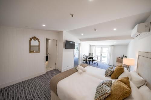 a bedroom with a large white bed in a room at Seahorse Inn Hotel & Villas in Eden