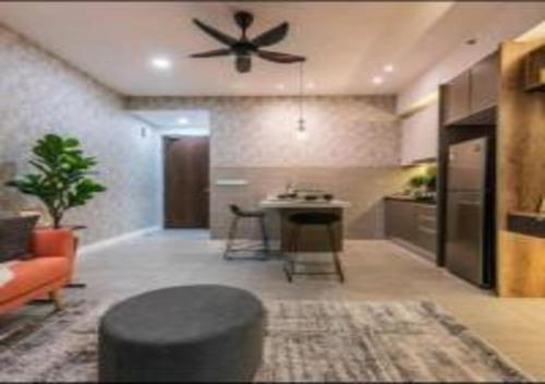a living room with a table and a ceiling fan at KLIA Glorybnb Bell Suites in Sepang