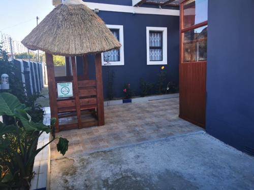 a room with a blue house with a door and a patio at The Zion Hill in East London