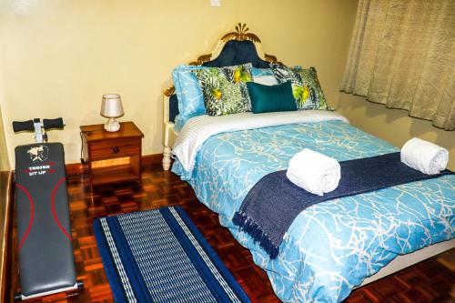 a bedroom with a bed and a guitar in it at Royal Strata House in Nanyuki