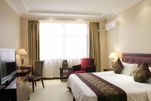 a hotel room with a bed and a large window at Zambia Golden Peacock Hotel in Lusaka