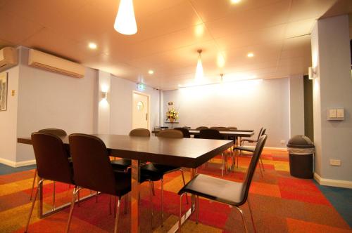 a meeting room with tables and chairs in a building at Kangaroo Inn in Perth