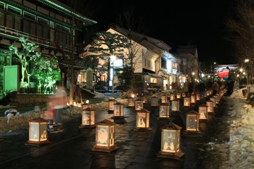 a group of candles on a street at night at Hotel Metropolitan Nagano in Nagano