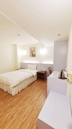Postel nebo postele na pokoji v ubytování Apple Hotel