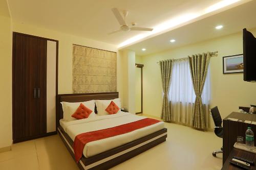a bedroom with a large bed in a room at Hotel Premiere Villa in Varanasi
