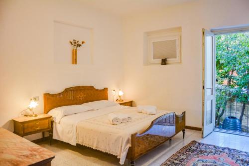 a bedroom with a bed and a large window at Bellagio Villas in Lezzeno