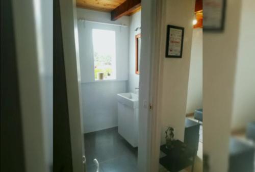 a bathroom with a toilet and a sink and a window at Casa Candela in Tinajo