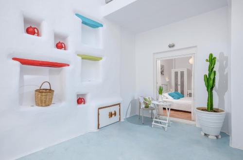 a white room with a table and a cactus at Adriani Hotel in Naxos Chora