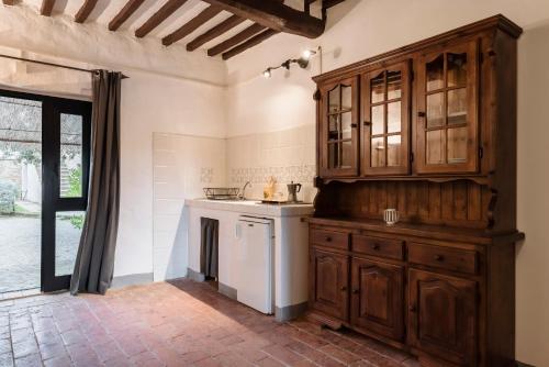 a kitchen with wooden cabinets and a white dishwasher at Agriturismo San Ottaviano in Monterotondo