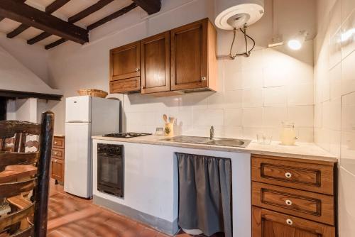 a kitchen with a white refrigerator and a sink at Agriturismo San Ottaviano in Monterotondo