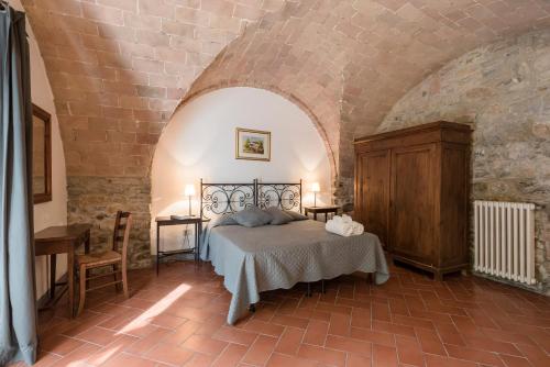 a bedroom with a bed in a brick wall at Agriturismo San Ottaviano in Monterotondo