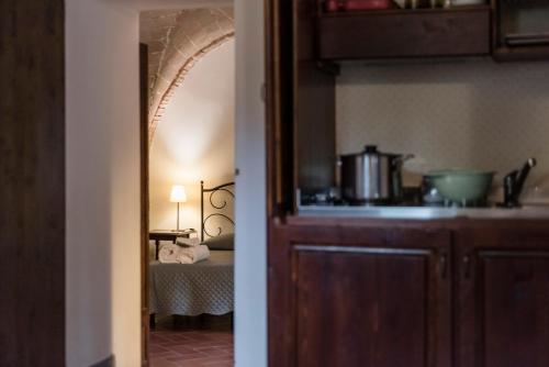 a kitchen with a sink and a room with a bed at Agriturismo San Ottaviano in Monterotondo