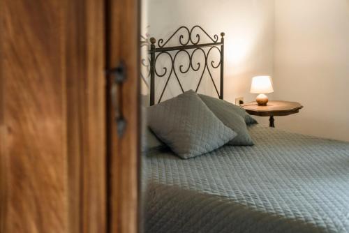 a bedroom with a bed with a pillow and a table at Agriturismo San Ottaviano in Monterotondo
