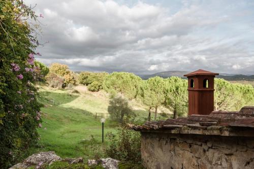 a view of a field from a stone wall at Agriturismo San Ottaviano in Monterotondo