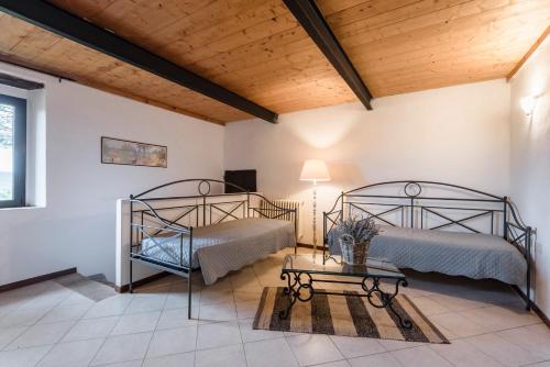 a bedroom with two beds and a table at Agriturismo San Ottaviano in Monterotondo