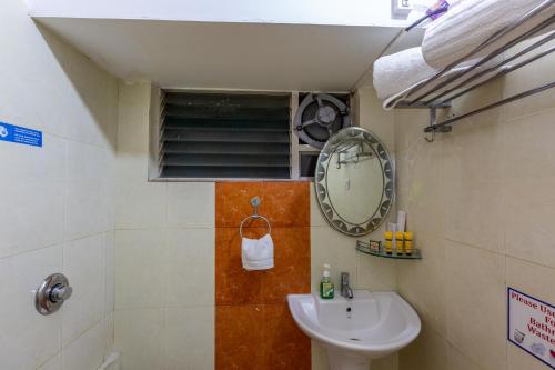 a bathroom with a sink and a mirror at KSTDC Mayura Durg Chitradurga in Chitradurga