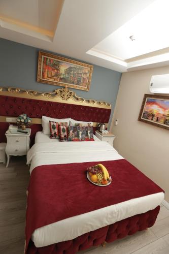 a bedroom with a bed with a plate of food on it at Constantinopolis Hotel in Istanbul