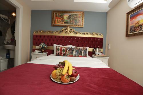 a plate of fruit on top of a bed at Constantinopolis Hotel in Istanbul