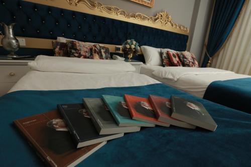a pile of books sitting on top of two beds at Constantinopolis Hotel in Istanbul