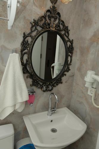 a bathroom with a sink and a mirror on a wall at Constantinopolis Hotel in Istanbul