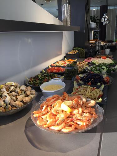 a buffet line with many different types of food at ibis Styles Paris Roissy-CDG in Roissy-en-France