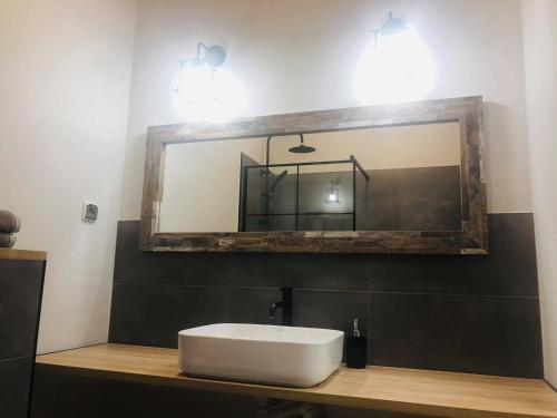 a bathroom with a sink and a mirror at Property Apart - Soft Lofty Legnicka Centrum in Wrocław