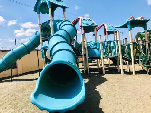 a row of slides in a playground at Milimani apartments10 in Nakuru