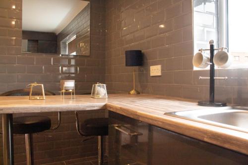 a kitchen with a counter and a sink and a window at Forth Apartments in Kirkcaldy
