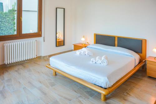 a bedroom with a bed with two towels on it at Bellagio Villas in Lezzeno