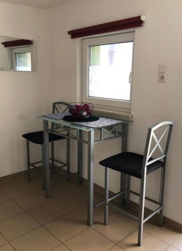 a table and chairs in a room with a window at Agnieszkas Pension in Havelberg