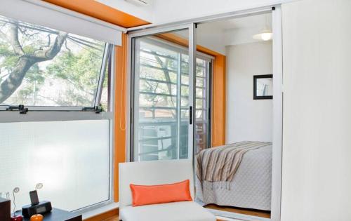 a bedroom with a bed and a large window at Apartamento en Palermo in Buenos Aires