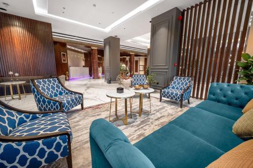 a lobby with a couch and chairs and a table at Suknai Royal Hotel in Hail