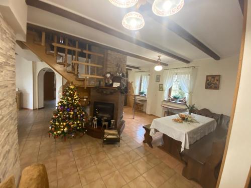 a living room with a christmas tree and a fireplace at Chalet Trostian in Slavske