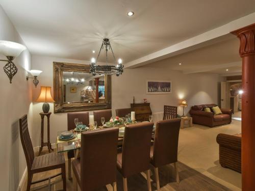a dining room and living room with a table and chairs at Yew Tree Nook in Ashbourne