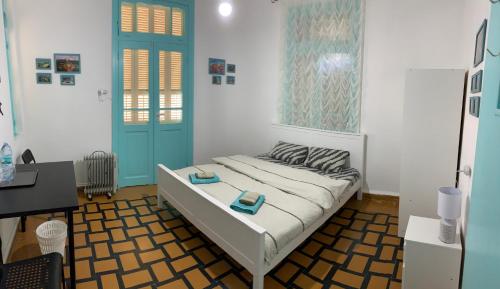 a bedroom with a bed with a blue door and a desk at Apartments COMFY - for a quiet family holiday in Haifa