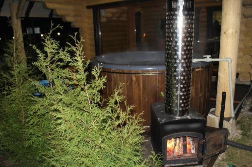 a wood fired stove in a yard with a tub at Айворі Хаус in Mykulychyn