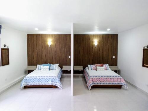 Una cama o camas en una habitación de VILLA D-SPITIA Apartamentos en renta