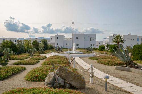 a garden with a fountain in the middle at Dolphin Studios in Agia Anna Naxos