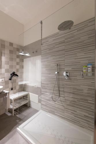 a bathroom with a shower with a glass door at Dante Square in Naples