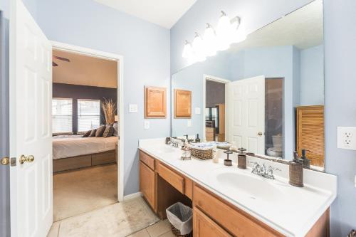 a bathroom with a sink and a mirror at Cozy home near Houston Medical Center, NRG Stadium and Galleria in Manvel