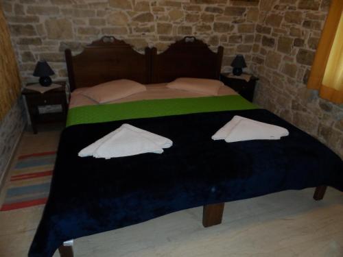 a bedroom with a bed with two pillows on it at Sivas Apartments-Studios,Sigelakis with very nice view in Sívas