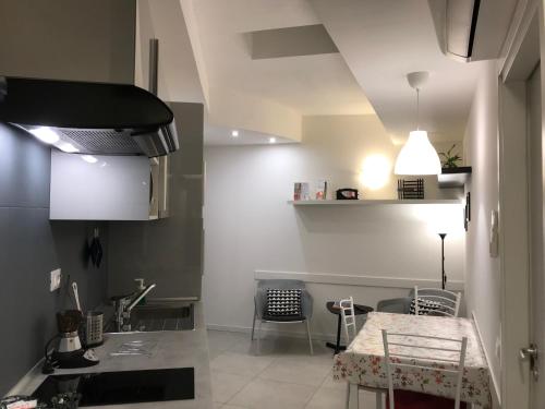 a kitchen with a sink and a table with chairs at Appartamenti Borghetto San Donato 105 in Bologna