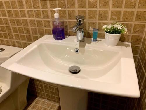 a white sink in a bathroom next to a toilet at لافينا حائل للاجنحة الفندقية in Hail