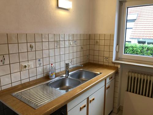 a kitchen with a sink and a window at Gästehaus Alm-Blick in Murrhardt