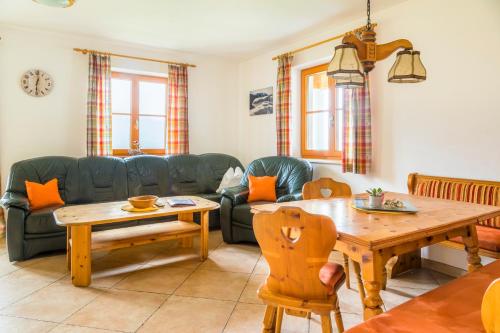 a living room with a couch and a table at Daarhof in Wagrain